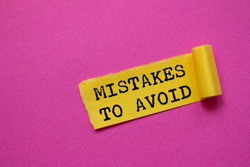 Mistakes to avoid message written on ripped torn yellow paper piece on pink background. Conceptual mistakes to avoid symbol. Copy space.