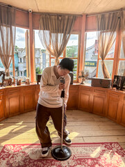 A performer sings with passion into a vintage microphone surrounded by warm wooden decor