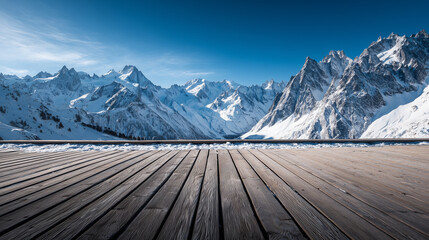 Scenic snowy peaks with empty wood deck foreground