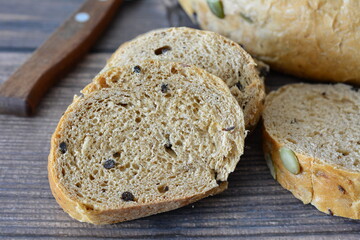 Sliced Whole Wheat Bread with Pumpkin Seeds on a Wooden Table macro