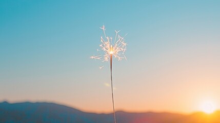 Sparkler Glowing in Sunset with Mountains in Background Creating Festive Atmosphere for Celebrations and Events