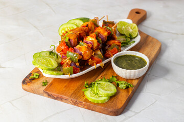 Paneer satay is a grilled Indian appetizer made with marinated paneer cubes, skewered, and served with spicy peanut or yogurt dip.
