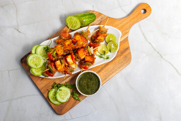 Paneer satay is a grilled Indian appetizer made with marinated paneer cubes, skewered, and served with spicy peanut or yogurt dip.
