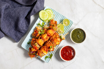 Paneer satay is a grilled Indian appetizer made with marinated paneer cubes, skewered, and served with spicy peanut or yogurt dip.

