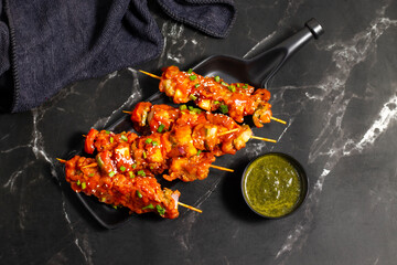 Paneer satay is a grilled Indian appetizer made with marinated paneer cubes, skewered, and served with spicy peanut or yogurt dip.
