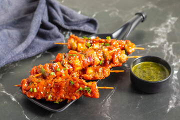 Paneer satay is a grilled Indian appetizer made with marinated paneer cubes, skewered, and served with spicy peanut or yogurt dip.
