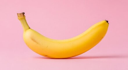 Ripe yellow banana isolated on a pastel pink background