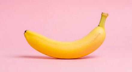 Vibrant yellow banana fruit with a soft pink background, showcasing healthy eating and fresh produce concepts