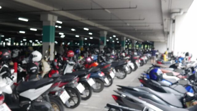 Blurred motorcycle parking lot at modern commercial building shopping mall office condominium residential complex.