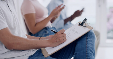 Hands, person writing on clipboard in waiting room for doctor, medical consultation or insurance form. Patient, filling in paperwork for healthcare registration, information and symptoms of sickness.
