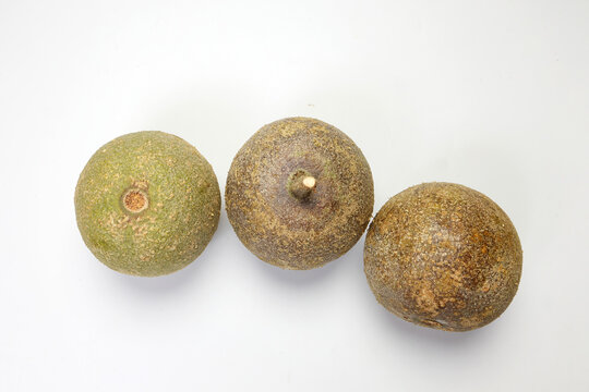 Hard shelled rare exotic fruit sour tangi wood apple kod bel on white background