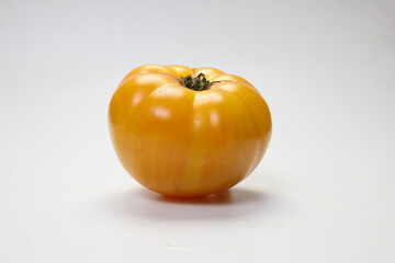 fresh ripe yellow variety tomato cosmonaut volkov on white background