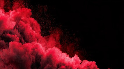 Vibrant red smoke clouds and particles explode across a stark black background creating an abstract atmospheric effect fire background