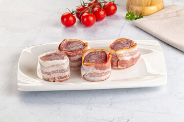 Raw pork tenferloin with bacon
