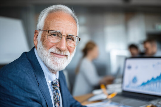 Senior business man working on pc computer with financial charts at office
