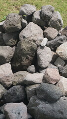 A pile of neatly arranged gray stones, outdoors, taken in closeup