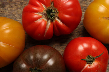 variety assortment of tomato red yellow maroon beef breakfast on rustic wood jute rope table background