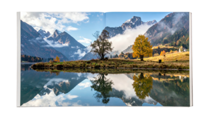 Mountains, lake, and colorful trees reflected in calm waters