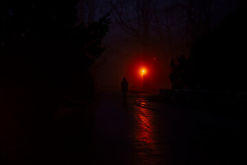 Mysterious person walking in the fog