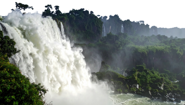 Massive waterfall cascading down from lush green cliffs