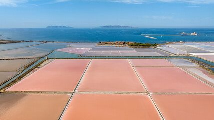 Aerial view of the Trapani salt pans, Sicily, Italy. Wide view of salt evaporation ponds. The Aegadian Islands are in the background.