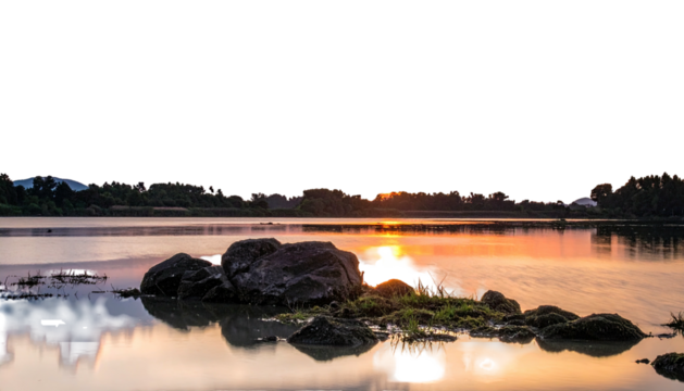 Sunset on lake, rocks, water reflecting light, dark sky above