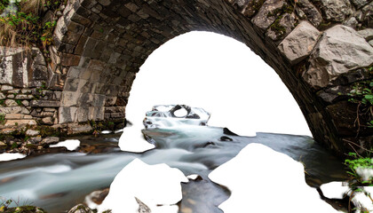 Stone bridge arches, with water cascading beneath