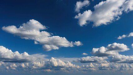 Obraz premium Vast blue sky with fluffy white cumulus clouds on a sunny day featuring clear atmosphere and natural serenity