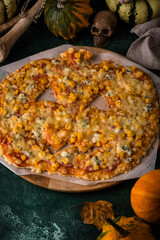 Halloween scary pizza in shape of pumpkin