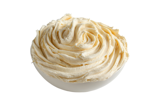 Creamy swirl of frosting filling white bowl against black background, soft texture
