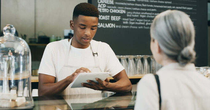 Waiter, customer and tablet in startup for service, order system and efficient hospitality in cafe. Man, tech and client in coffee shop for POS app, menu information and support local small business
