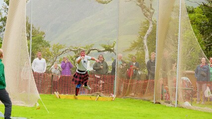 Athlete Throws Hammer at Highland Games Competition in Scotland
