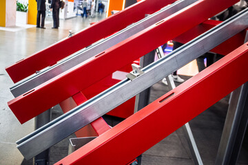 Modern red and metallic silver solar panel mounting frames on display at an exhibition, showcasing innovative energy solutions and industrial design. Ideal for renewable energy concepts.
