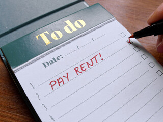 Close up of pay rent written on To Do list with red marker. Handwritten Rent Payment