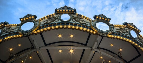 Carousel roof with lights against a blue sky