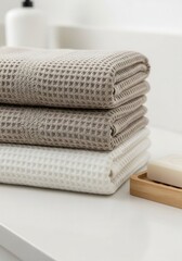 A stack of towels sitting on top of a white counter