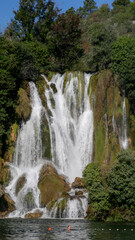 Majestic waterfall dances over mossy cliffs, nature's symphony, hidden oasis; perfect for National Relaxation Day, World Water Week