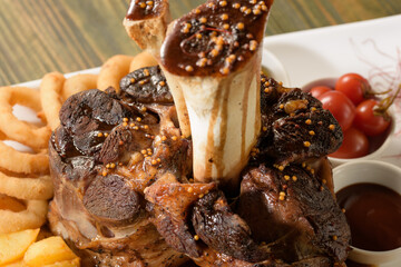 Beef shank on the bone with fermented cabbage, pickled tomatoes, baked potatoes, and teriyaki sauce