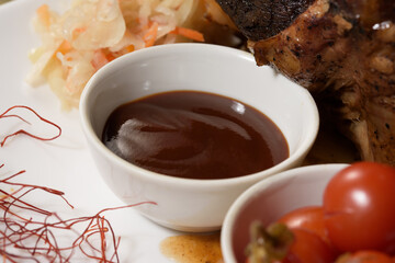 teriyaki sauce in a white plate for a meat dish