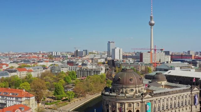 Aerial view of the Bode Museum's ornate dome and the towering TV Tower piercing the skyline under a clear sky, Berlin, Berlin, Germany.