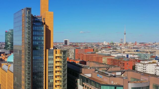 Aerial view of buildings with a tall tower in the distance at potsdamer platz, creating a captivating contrast against the clear blue sky, Berlin, Berlin, Germany.