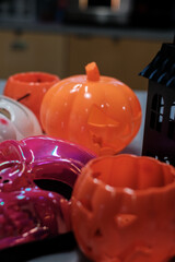 Colorful Halloween decorations with pumpkin buckets and skull mask, festive spooky setup for autumn holiday celebration