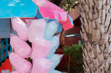 Cotton candy. Candy floss for sale at a wooden kiosk on the street.