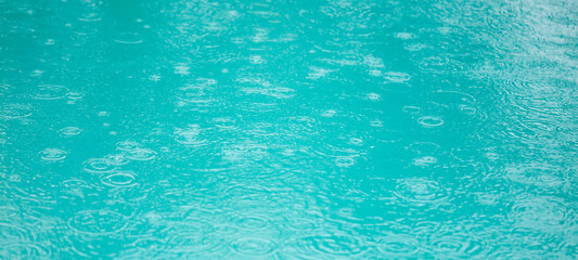 A body of water with raindrops falling on it