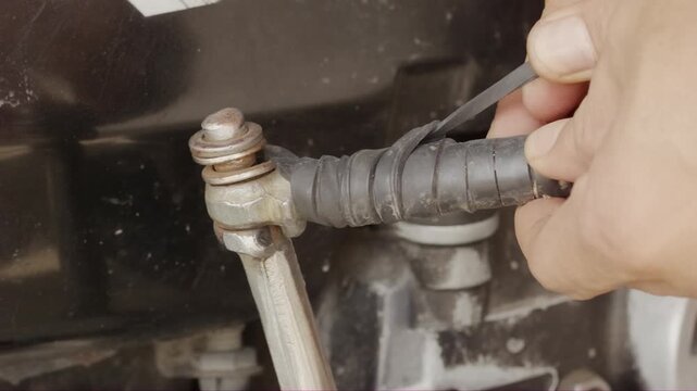 Mechanic fixing motorcycle kick starter with rubber tube part