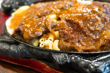 Taiwanese style sizzling beef steak with noodles, egg and black pepper sauce.