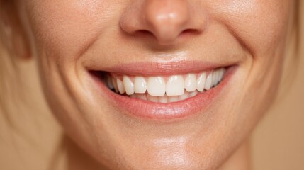 Obraz premium Close up of joyful woman smiling with healthy teeth and natural beauty in warm indoor lighting