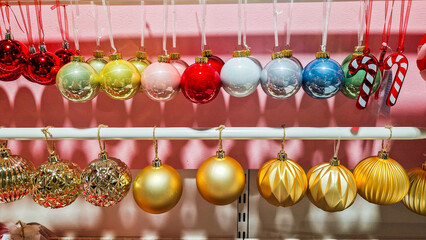 Colorful Christmas decorations including red, white, and blue ornaments, candy canes, and a red paper fan. Perfect for festive holiday settings.