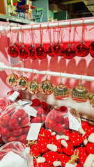 Colorful Christmas decorations including red, white, and blue ornaments, candy canes, and a red paper fan. Perfect for festive holiday settings.