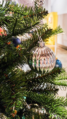 A decorated Christmas tree with various ornaments. The tree features green branches adorned with blue and silver baubles, creating a festive atmosphere.